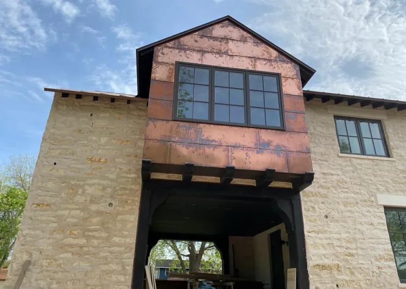 Copper metal panel facade on a stone building for Skylight Installation in Ralston
